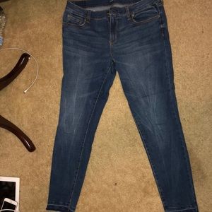 Dark wash skinny jeans with frayed bottoms